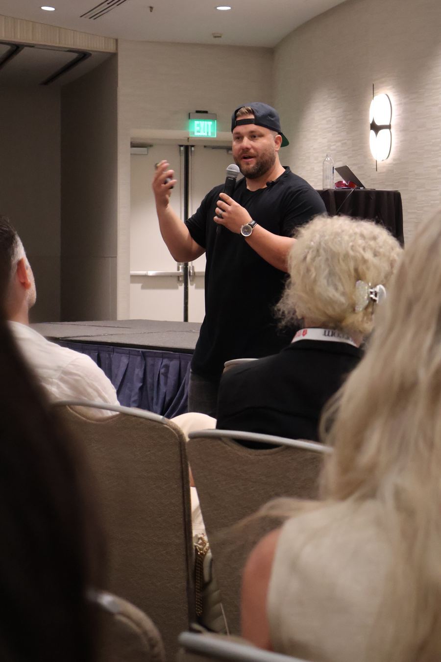 Jeremy Davis speaking with a microphone in front of an audience